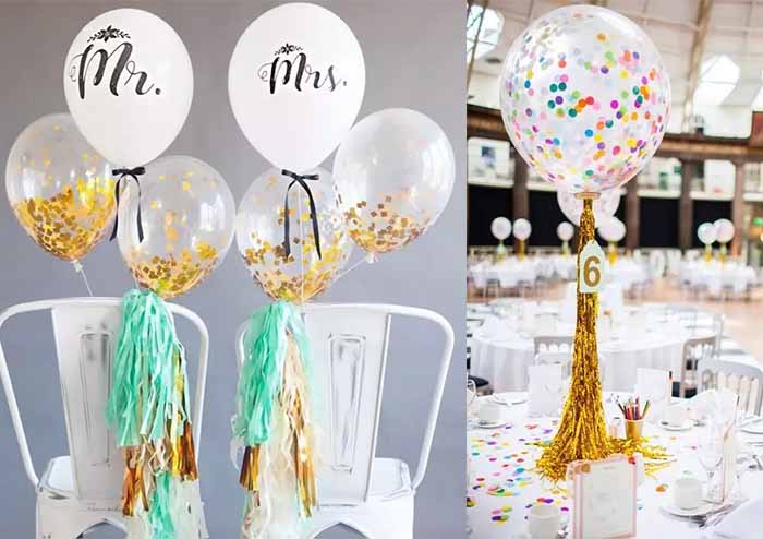 Transparent balloons with colorful scraps of paper inside as wedding decorations