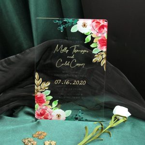 Crystal clear acrylic wedding invitation HPA290 with vibrant pink watercolor flowers and metallic gold text inside a translucent transparent envelope