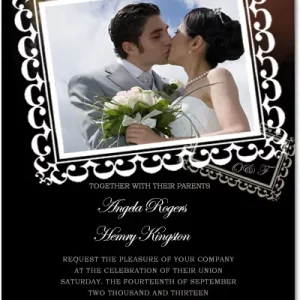 Romantic photo wedding invitation featuring a couple kissing inside an ornate white frame on a black background with elegant script text