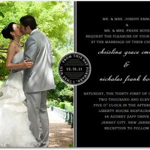Black and white photo wedding invitation featuring romantic couple image on left side with elegant typography and formal black layout on right side
