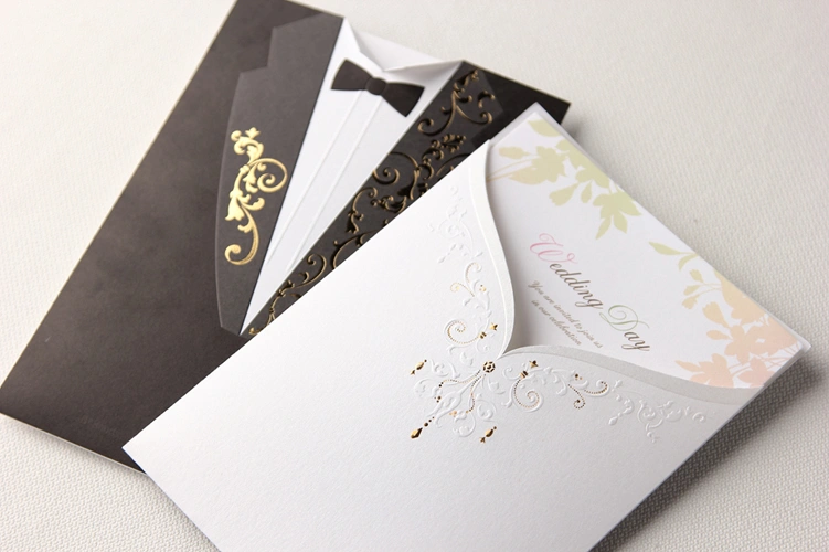 Black and white pocket fold wedding invitation with gold foil accents and printed insert