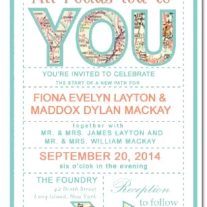 Travel-themed wedding invitation featuring map typography spelling YOU with pastel teal and coral colors and romantic quote “All roads lead to you”