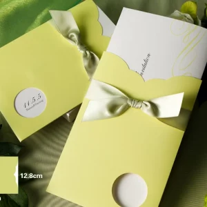 lemon yellow pocket wedding invitation with satin ribbon bow and scalloped flap design with size details